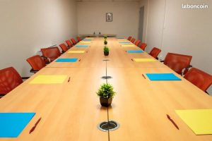 Longue table de réunion équipée de blocs-notes pour une formation